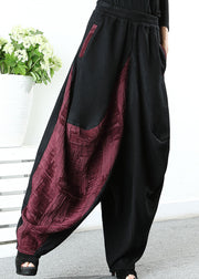 Stilvolle schwarze Patchwork-rote asymmetrische Designhose Winter